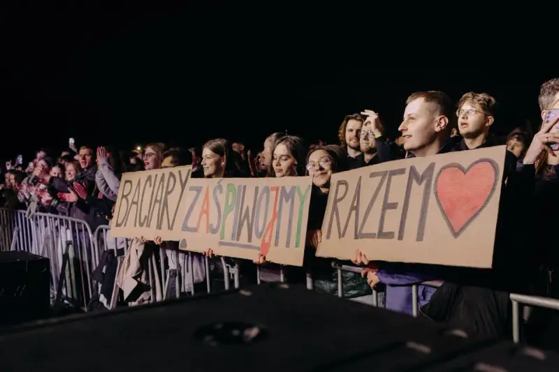 Fani trzymają transparent: "Baciary zaśpiewajmy razem" z sercem.